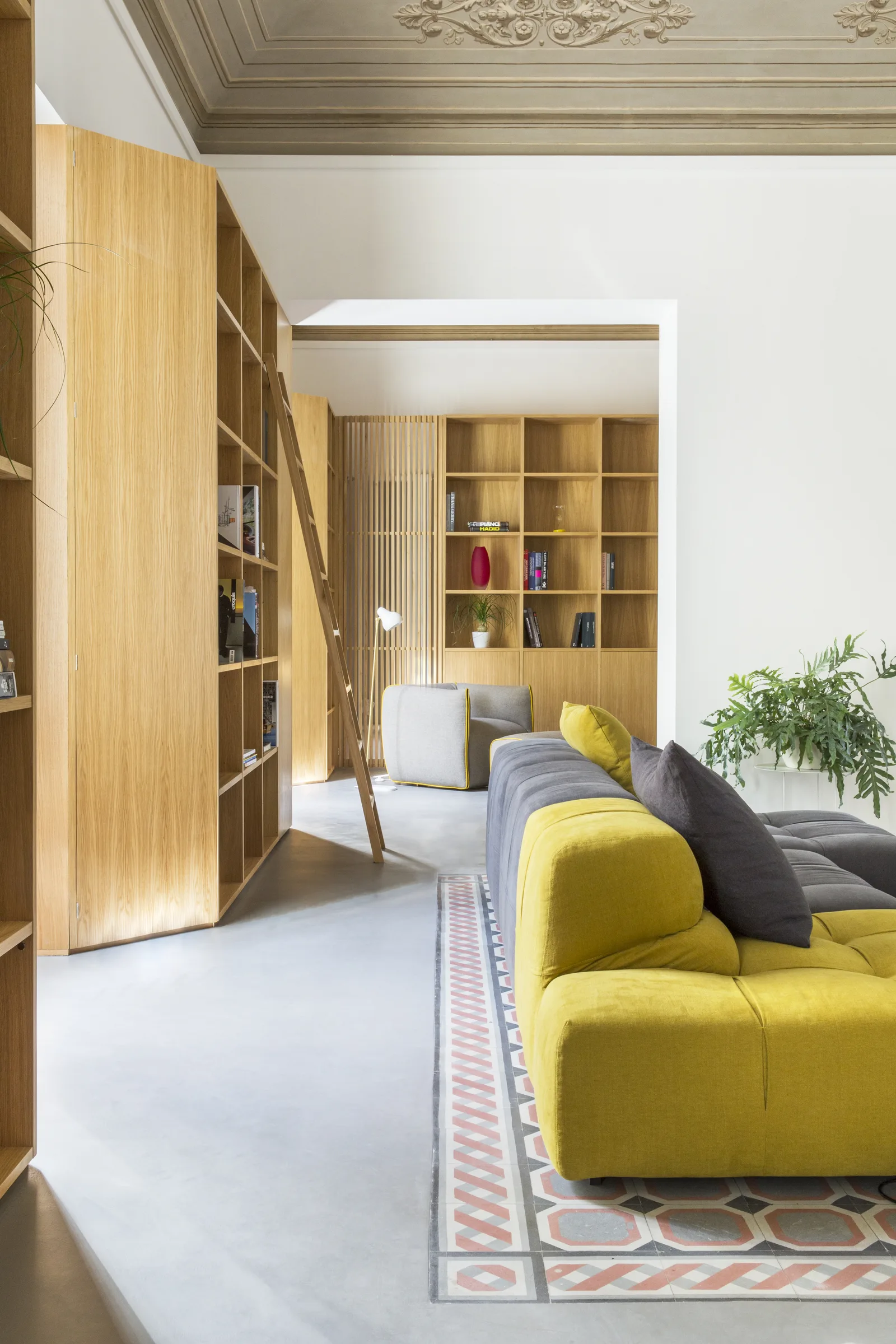 Yellow sofa beside an open oak door, with the decorated floor